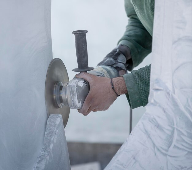 Worker cutting stone with grinder