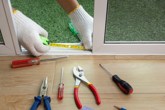 Worker fixing the insect screen sliding door