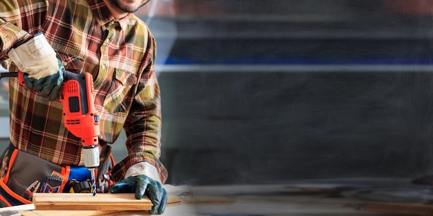 Worker holding an electric drill