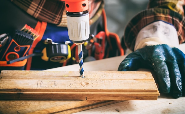 Worker holding an electric drill