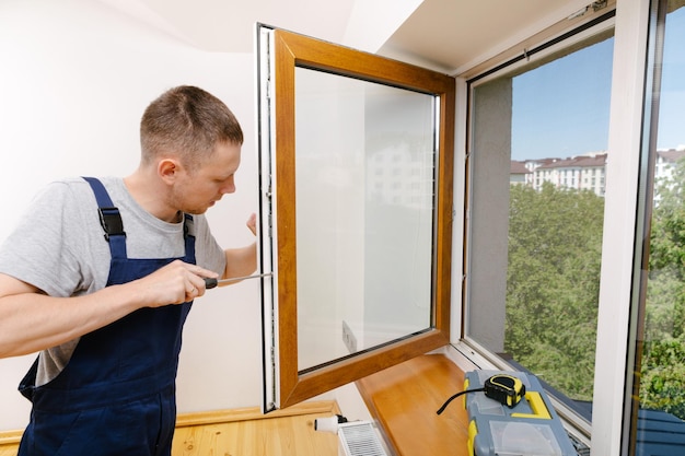 The worker installing and checking window in the house