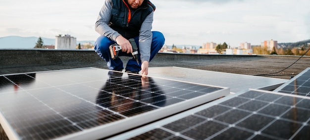 Worker installing new solar panels on roof of family house Alternative energy Cover photo