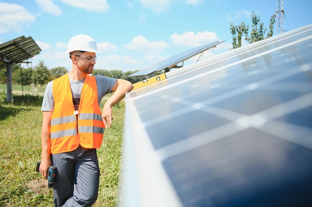 Worker installing solar panels outdoors