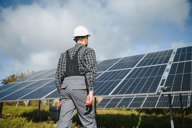 Worker installing solar panels outdoors