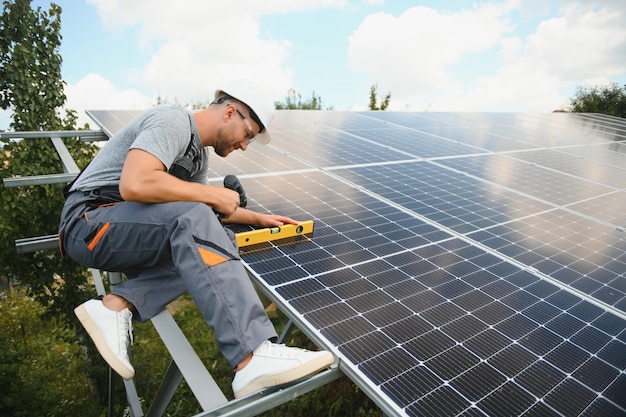 Worker installing solar panels outdoors