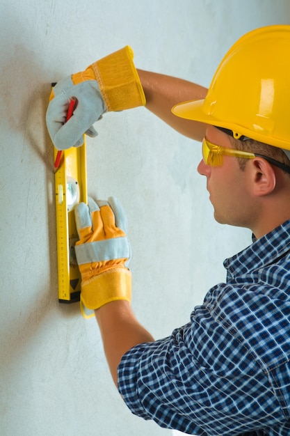 A worker layering on cocrette wall