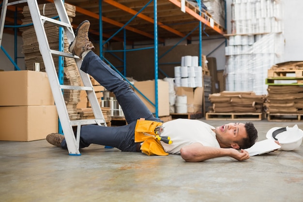 Worker lying on the floor in warehouse