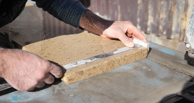 Worker measure tile for house building