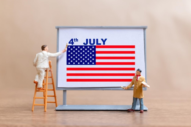 Worker paint on a billboard celebration of the Fourth of July and Independence Day