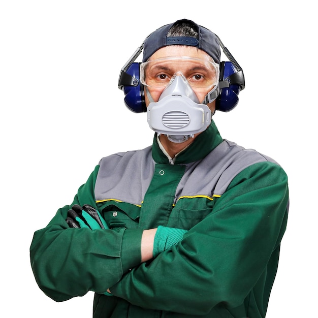 Worker in protective clothes headphones respirator and protection glasses on white