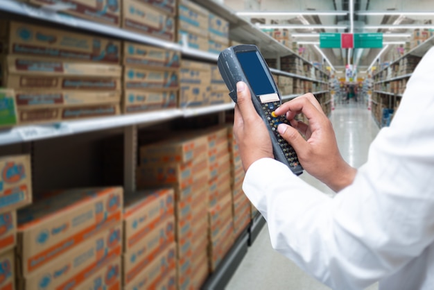 A worker scanning cargo with bluetooth barcode scan.