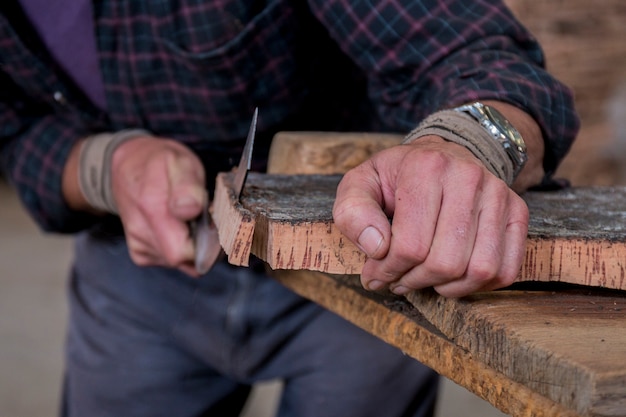 Worker slicing cork board