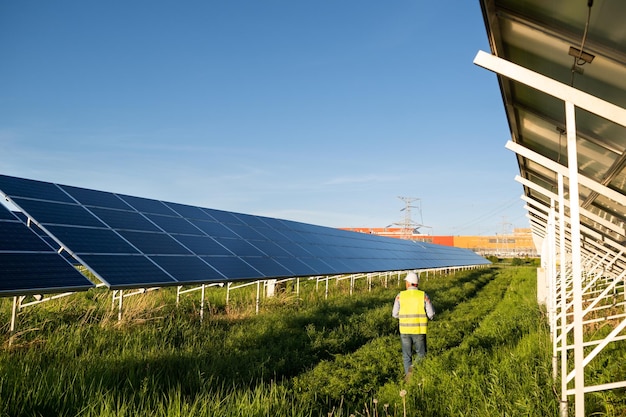 Worker in solar farm Solar photovoltaic panels Solar energy Eco concept