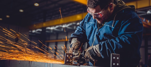 Worker Using Angle Grinder