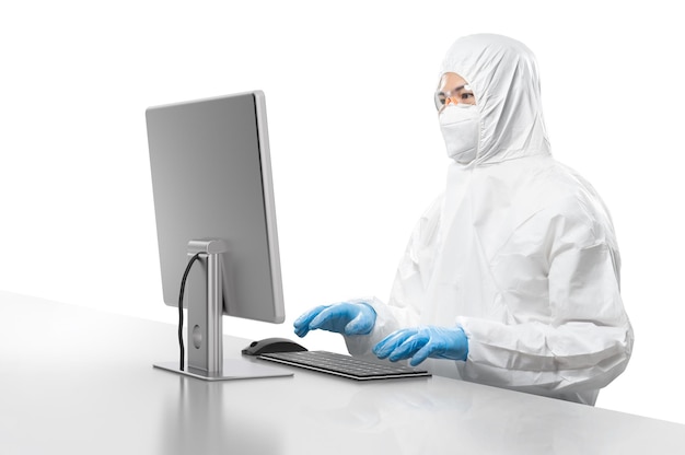 Worker wears medical protective or coverall suit work with computer isolated on white background