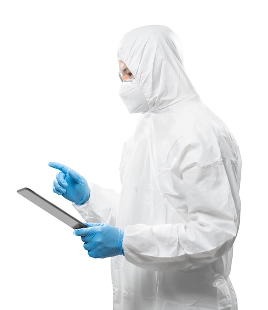 Worker wears medical protective suit or white coverall suit with digital tablet isolated on white