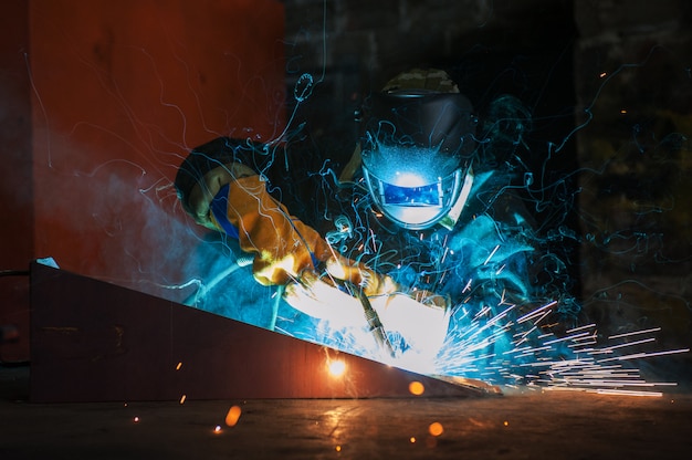 Worker welding metal