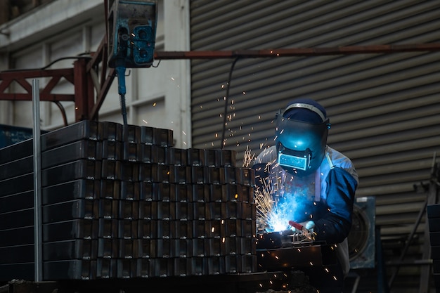 A worker welding steel, safety on job