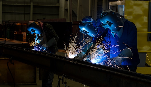 Worker with protective mask welding metal