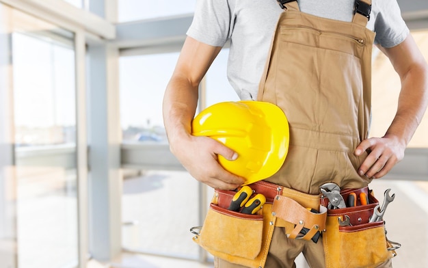 Worker with a tool belt. Isolated over  background.