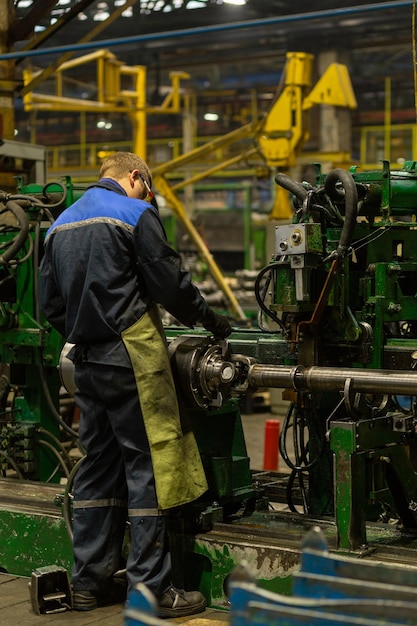 Worker on workplace of an employee of a plant for the production of cardan shafts