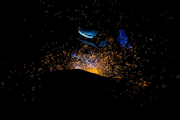 Workers are grooving with carbon welding wires With sparks