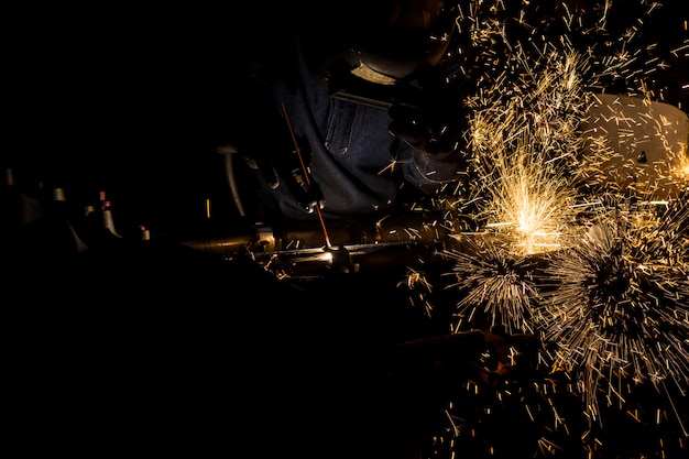 Workers are grooving with carbon welding wires With sparks