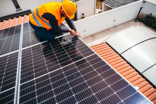 Workers assemble energy system with solar panel for electricity