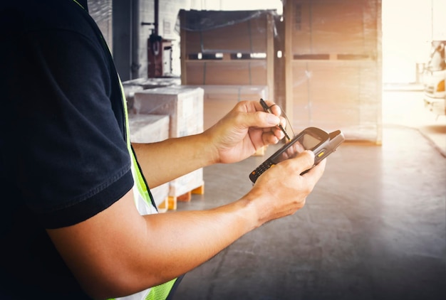 Workers Checking on A Smart Phone for Shipping to Customers