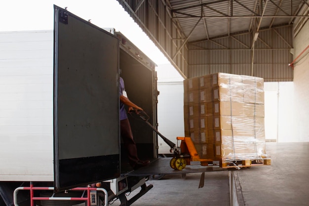 Workers Courier Unloading Package Boxes into Cargo Container Delivery Shipment Trucks Logistics