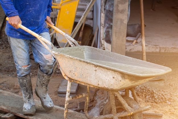 Workers pour concrete in the construction siteSteel bars used for floor construction working Workers pour for the construction of a residential buildingxA