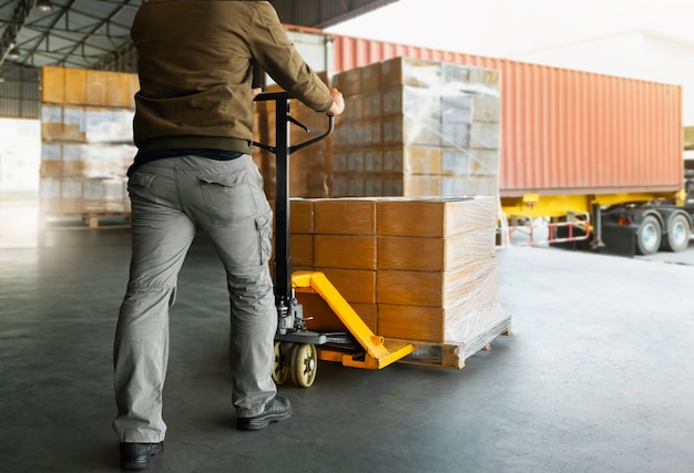 Workers Unloading Packaging Boxes on Pallets to The Cargo Container Trucks Shipping Warehouse