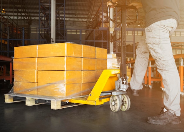 Workers Unloading Packaging Boxes on Pallets in The Warehouse Shipment Boxes Supplies Warehouse