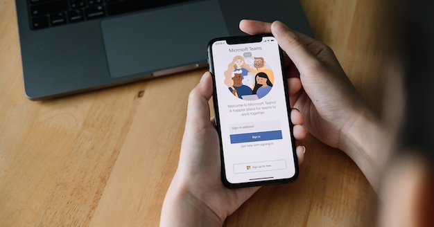 Photo a working from home employee is downloading the microsoft teams social platform, ready for remote working in isolation from home