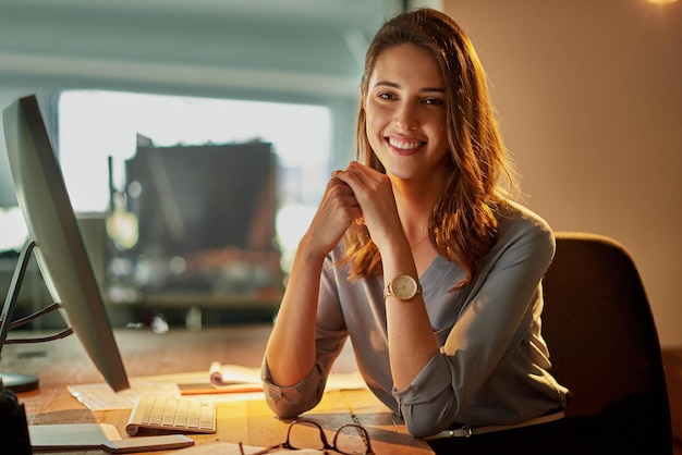 Working late has its upside Portrait of an attractive young businesswoman working late in the office