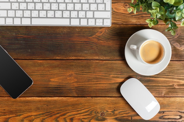 Working place at wooden desktop with coffee