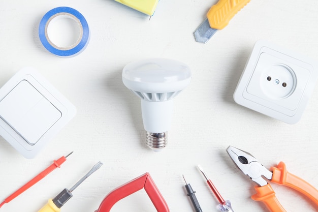 Working tools, light bulb and components. Electrical objects