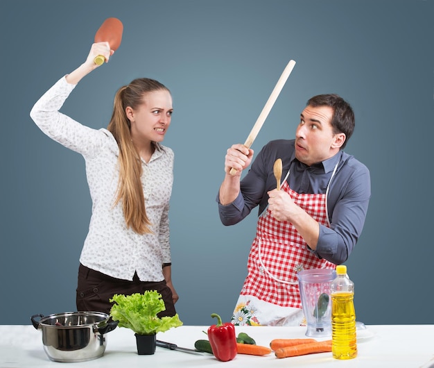 Working wife and househusband fighting in their kitchen