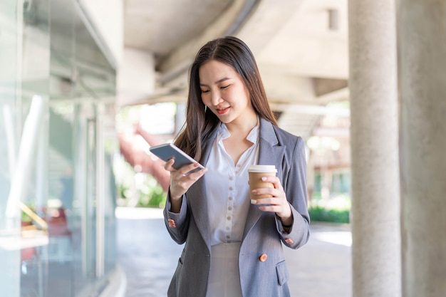 Working woman concept a young female manager attending video conference and holding a cup of coffee.