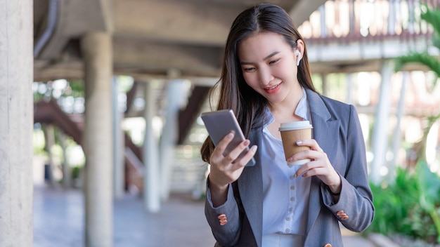 Working woman concept a young female manager holding a cup of coffee and communicating with the colleague via the video call.