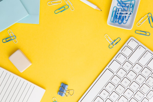 Workplace composition on yellow background with copy space