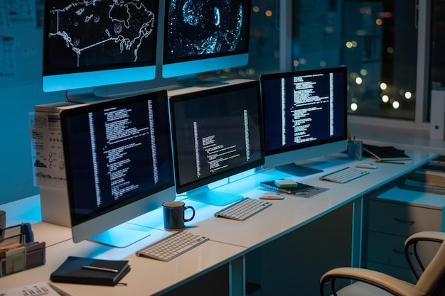 Workplace of it-engineers with three computers standing on desk