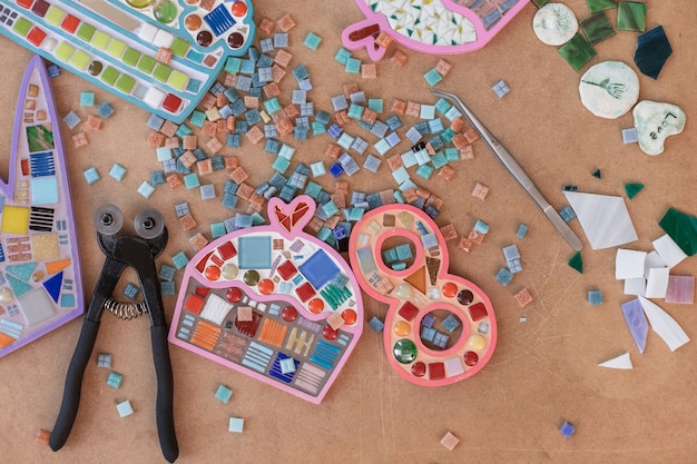 Photo workplace of mosaic maker: material and tools on wooden table