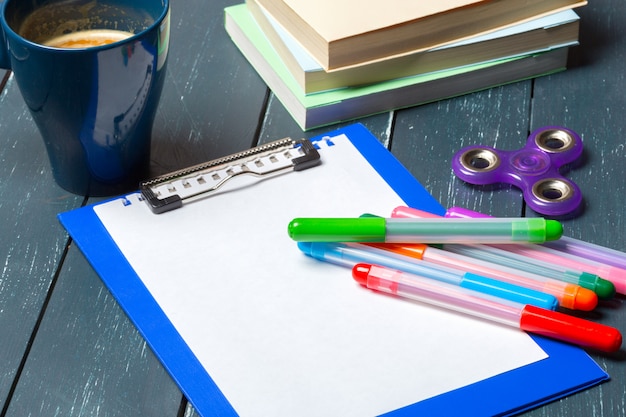 Workplace with coffee cup, spinner and book