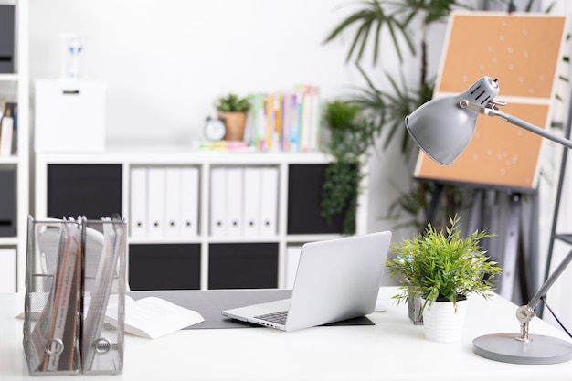 Workplace with notebook laptop Comfortable work table in office 