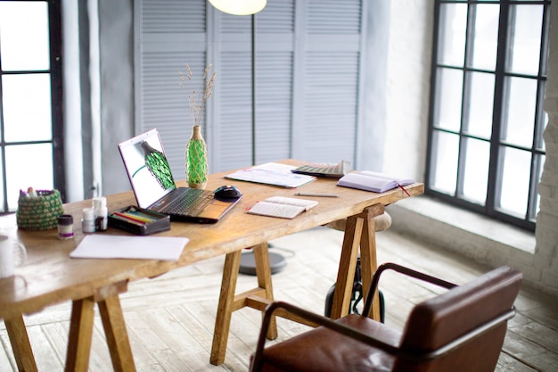 Workplace with a pen tablet, a computer and some color swatches