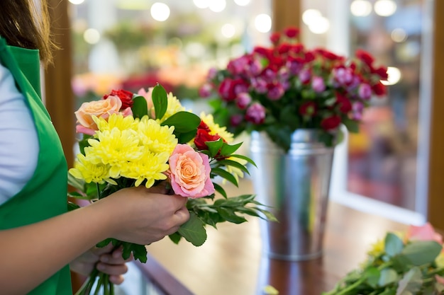 Workshop florist making bouquets and flower arrangements