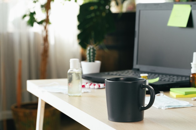 Workspace at home with laptop computer and coffee mug. Teleworking concept