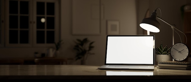 Workspace at night a laptop mockup a table lamp and decor on a desk