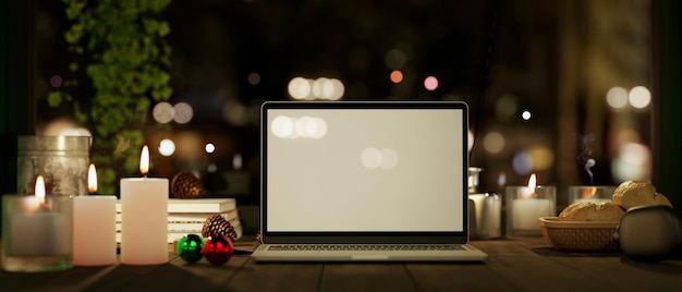 Workspace at night with laptop mockup with candles on wood table over blurred dark background